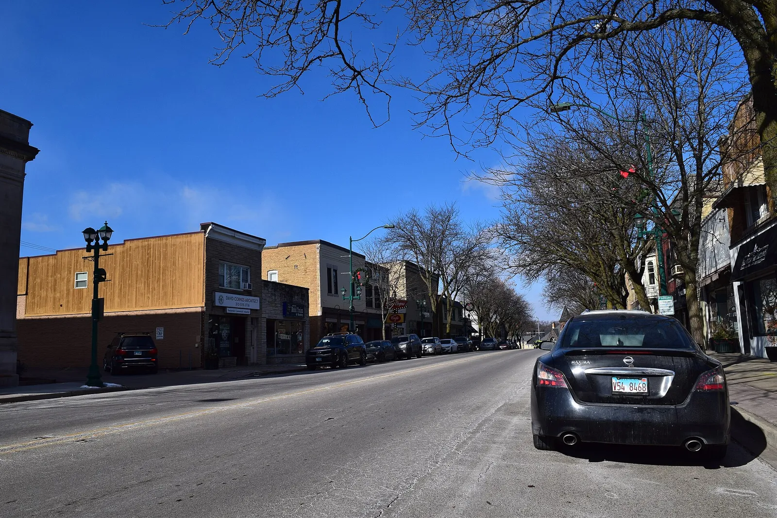 Brick storefronts and a tree-lined street in Antioch’s Route 83 business district