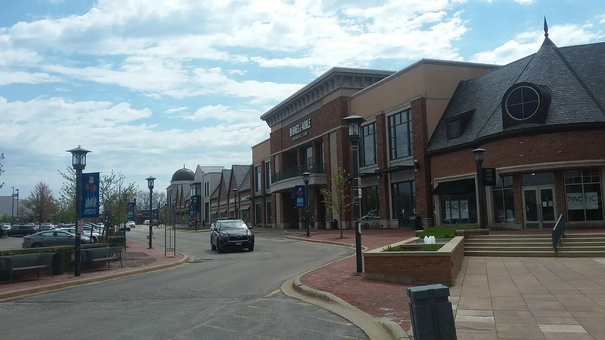 Brick storefronts, a curved drive, and the Barnes & Noble facade at Deerfield Square in May 2021