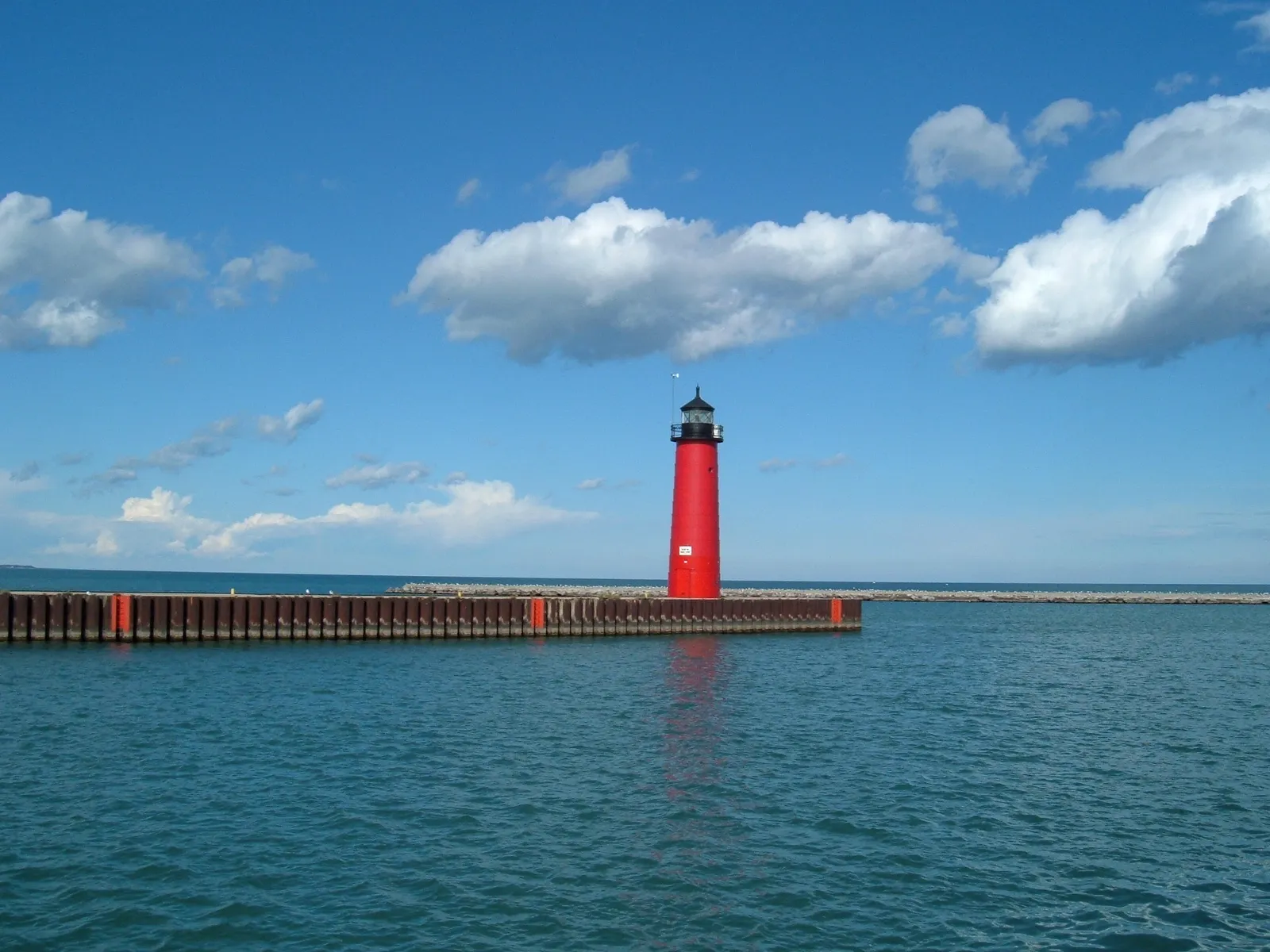 Red Kenosha North Pier Lighthouse at the end of the pier beside Lake Michigan