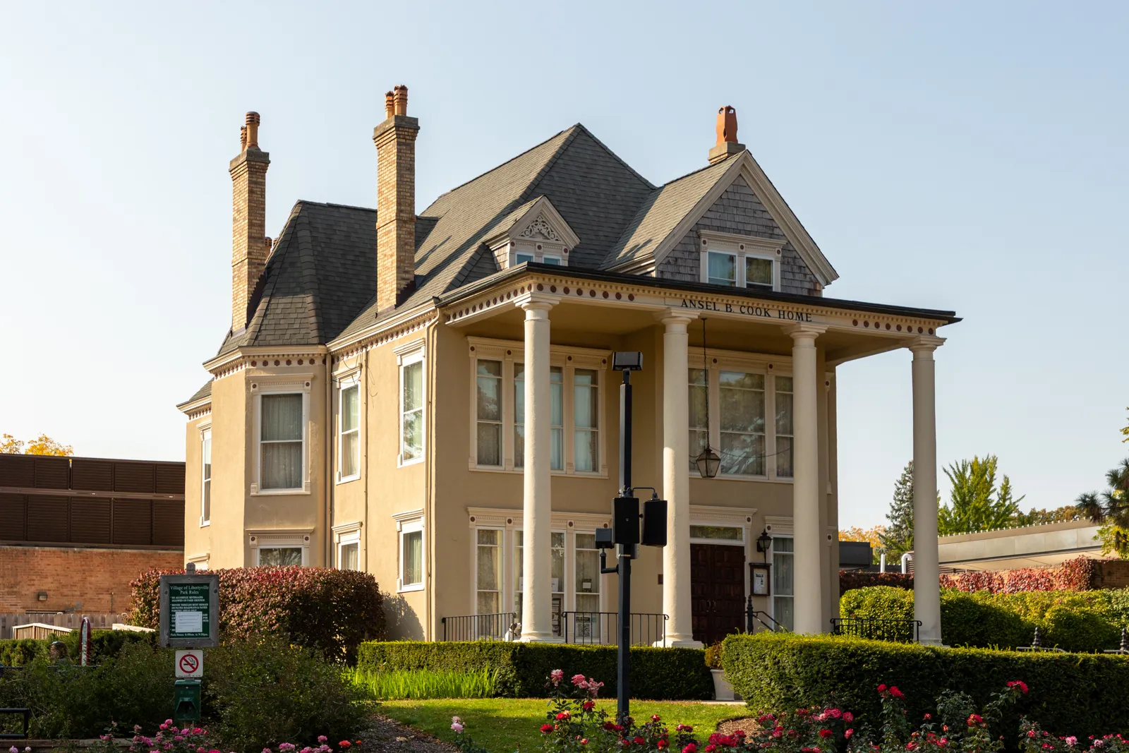 The Ansel B. Cook House in Libertyville with its porch, tall windows, and landscaped grounds