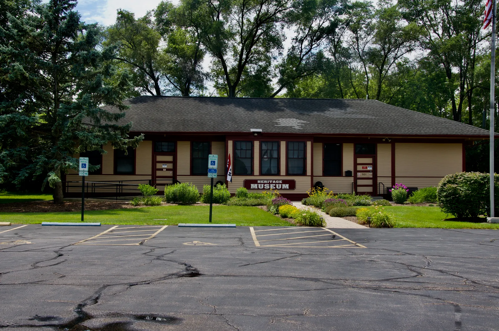 Mundelein Heritage Museum’s low brick and timber building with trees behind it